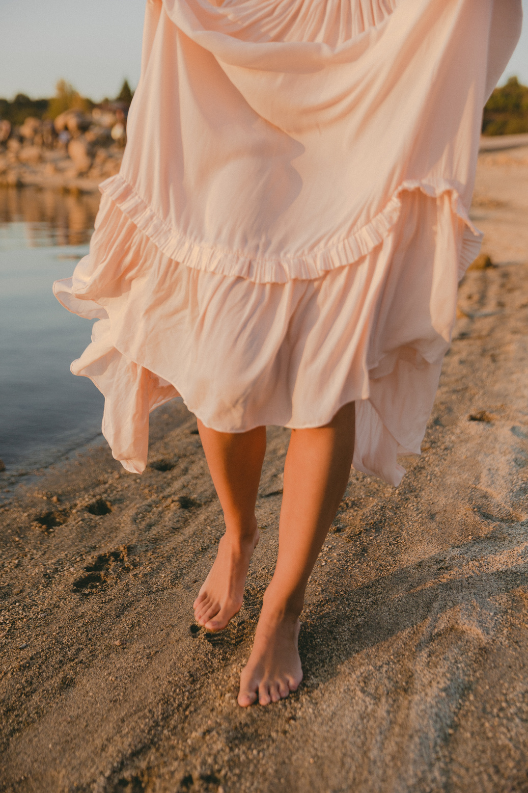 Woman in Sheer Dress Walking on the Shore